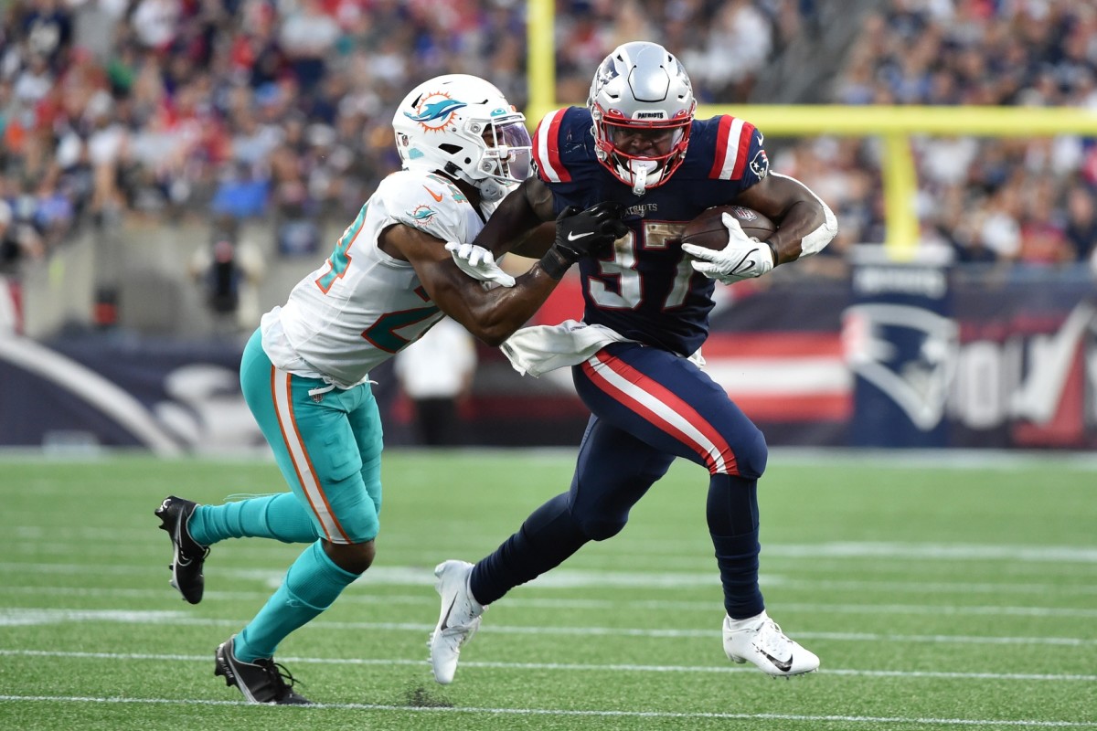 New England Patriots running back Damien Harris (37) runs the ball past Miami cornerback Byron Jones (24). Mandatory Credit: Bob DeChiara-USA TODAY Sports